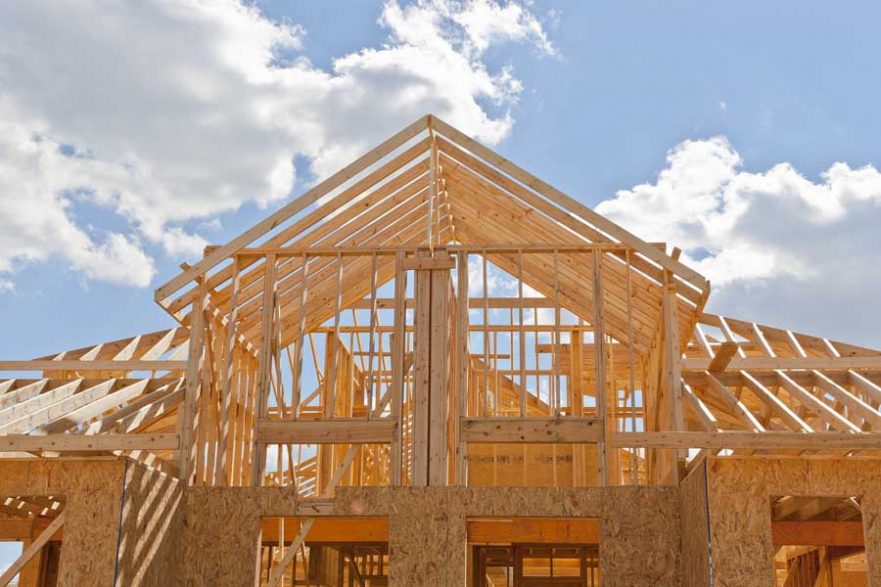 New Residential Construction Home Framing Against A Blue Sky